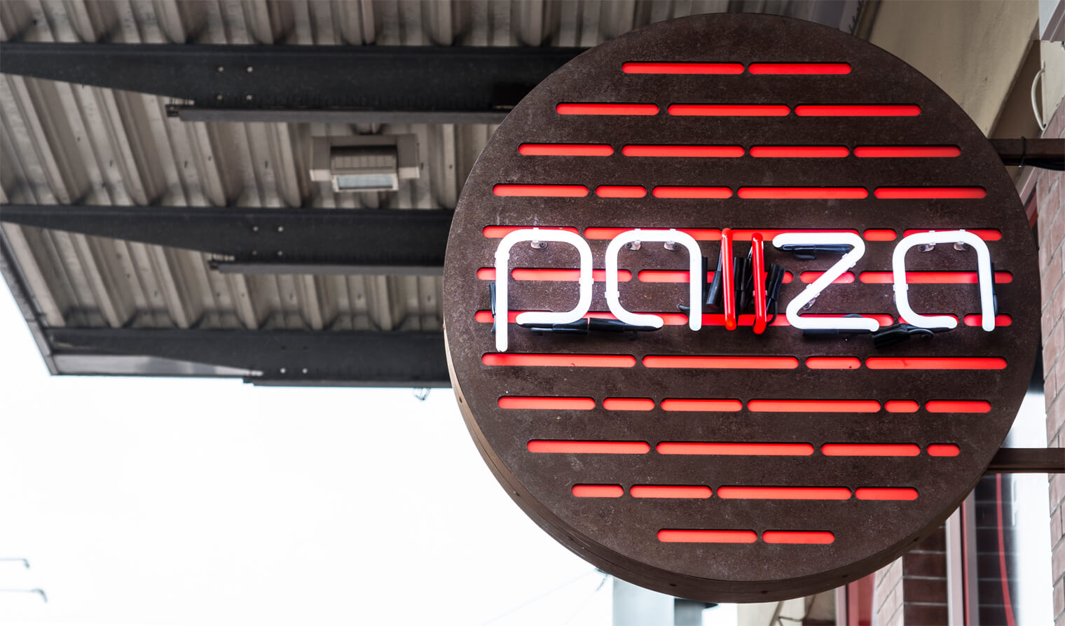 Pauze - loodrecht op reclamezuil, naast ingang